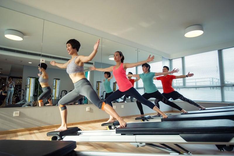 Woman practicing Pilates on a Reformer machine